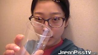 Sexy Japanese Cutie Urinates In A Cup While Perched On The Toilet
